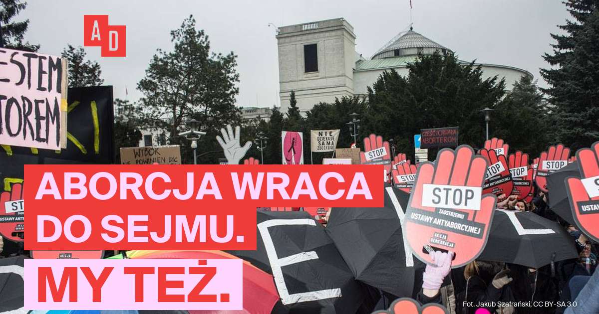 Tłum z czerwonymi tabliczkami STOP w kształcie dłoni pod Sejmem, w tle kopuła Sejmu. Napis: Aborcja wraca do Sejmu. My też.