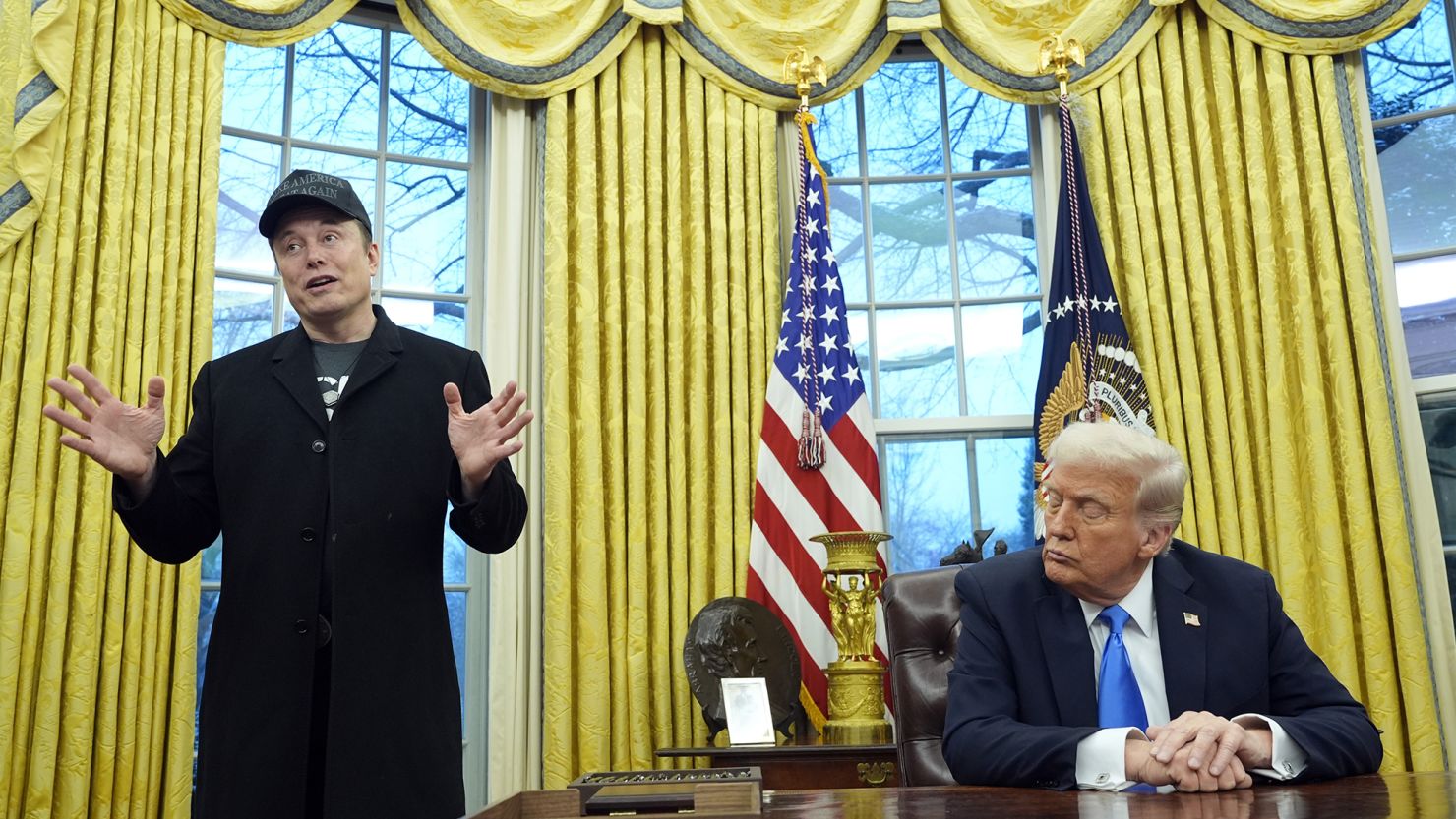Elon Musk in the White House with Trump listening to him