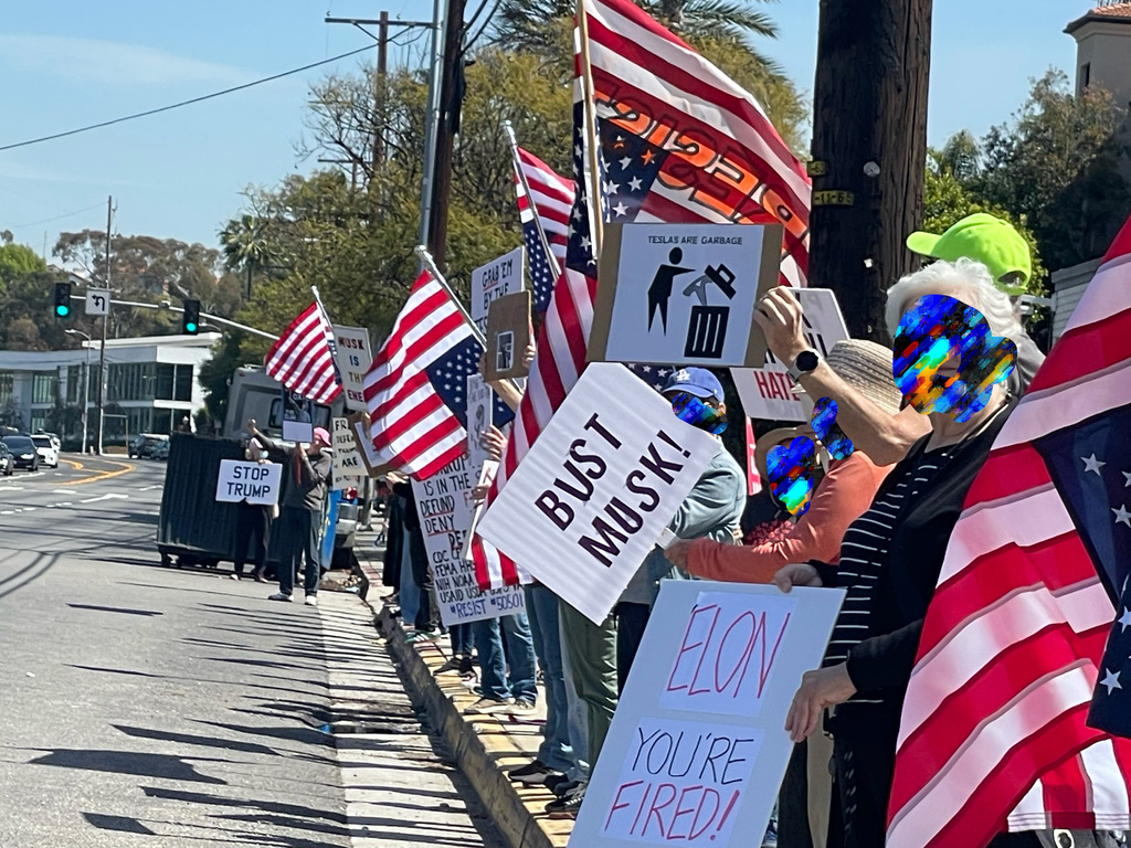 A group of our mighty protestors peacefully taking down Elon's false auto empire