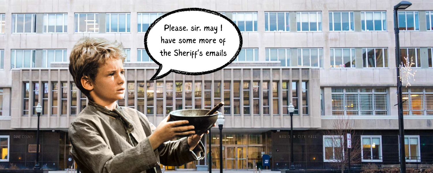 A boy holds a bowl up saying "Please, sir, may I have more of the Sheriff's emails". In the background is the City-County Building in downtown Madison.
