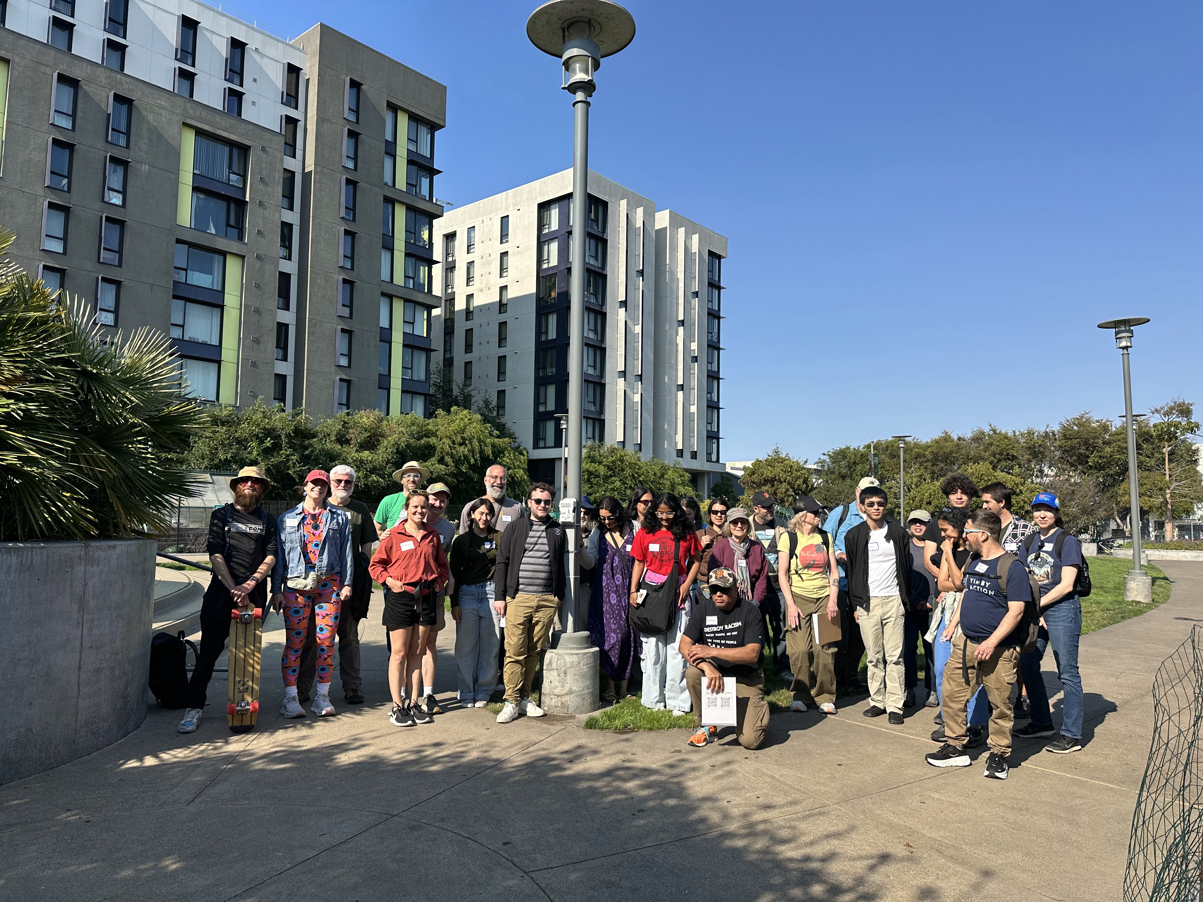 Group of happy green density tourist in front of affordable housing project