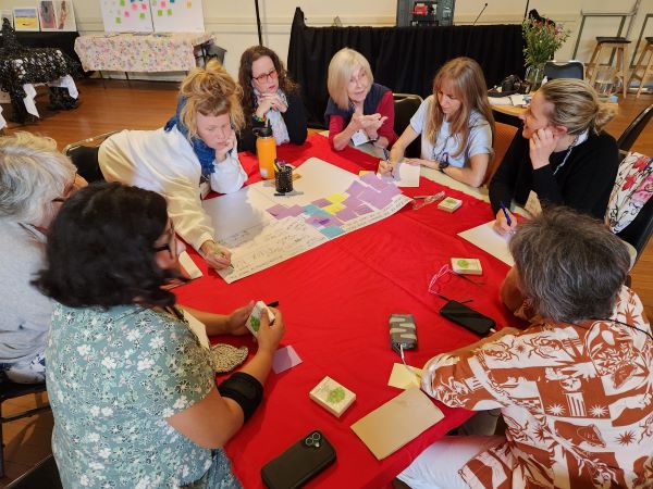Women at a workshop - working around tables. 