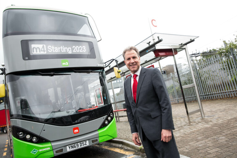 WECA Mayor Dan Norris in front of a West of England Bus in Bristol