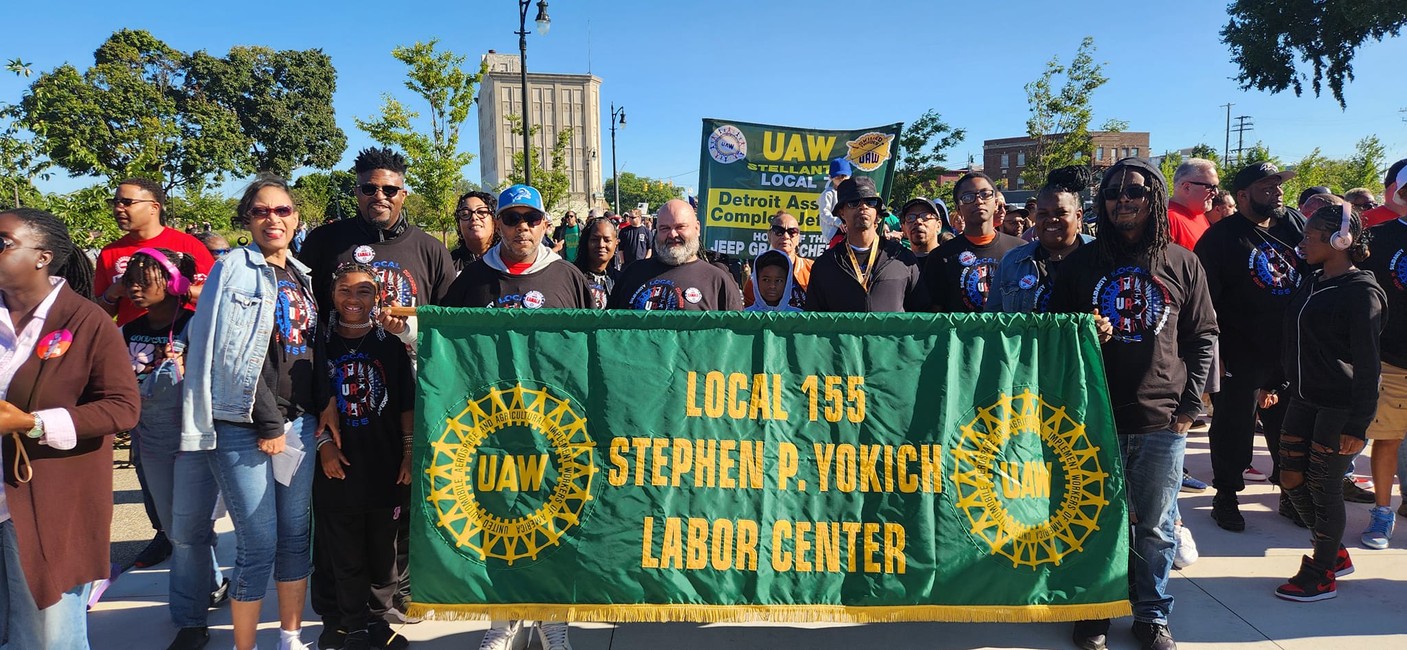 Members standing together with banner