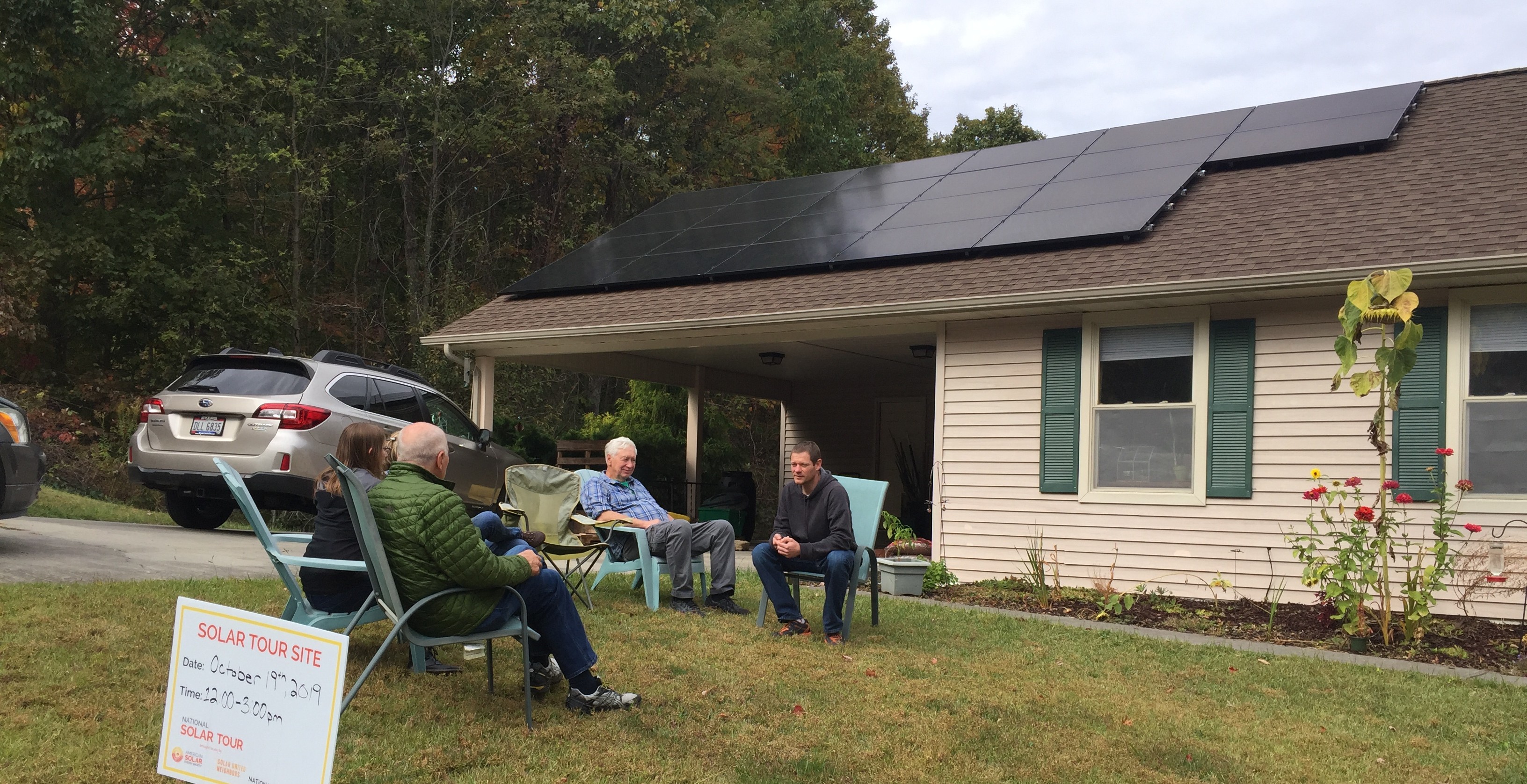 Facilitator and community members participate in an activity during a Solar Workgroup community meeting. 