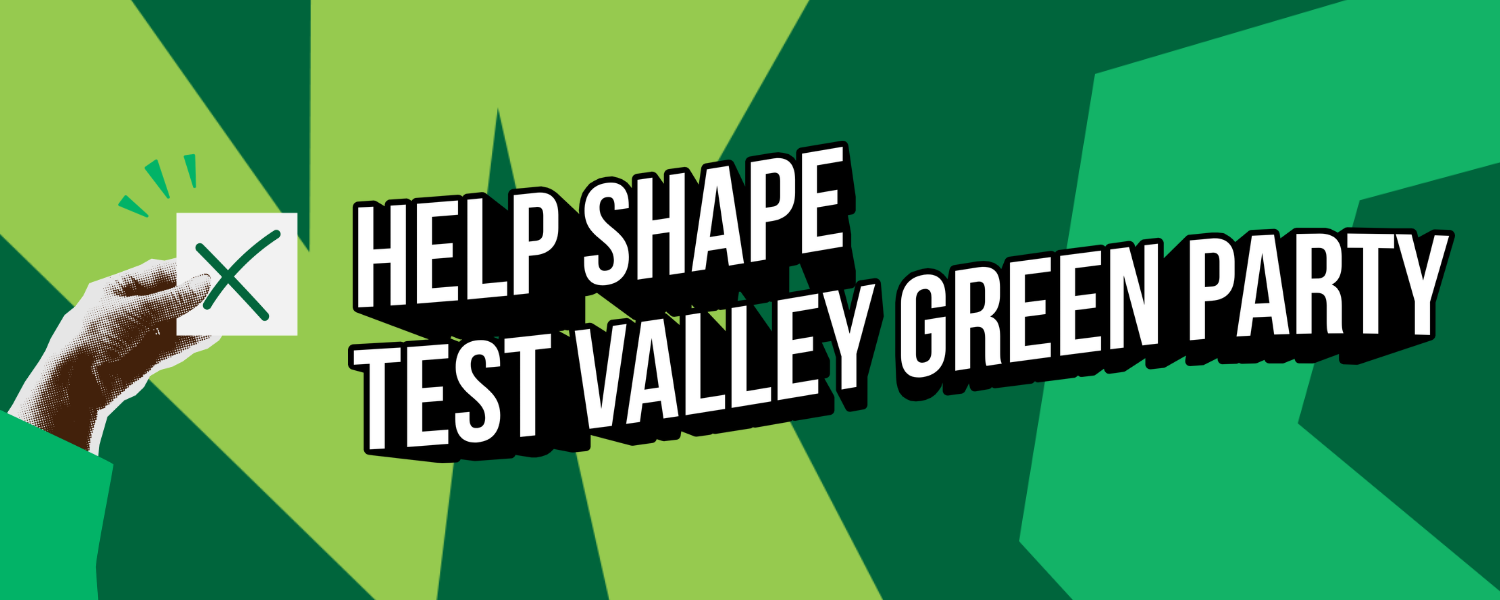 A wide banner image with a bold green geometric background in multiple shades of green. On the left, a halftone-style hand holds a white card marked with a green cross. Large white bold text with a dark outline reads "Help Shape Test Valley Green Party".