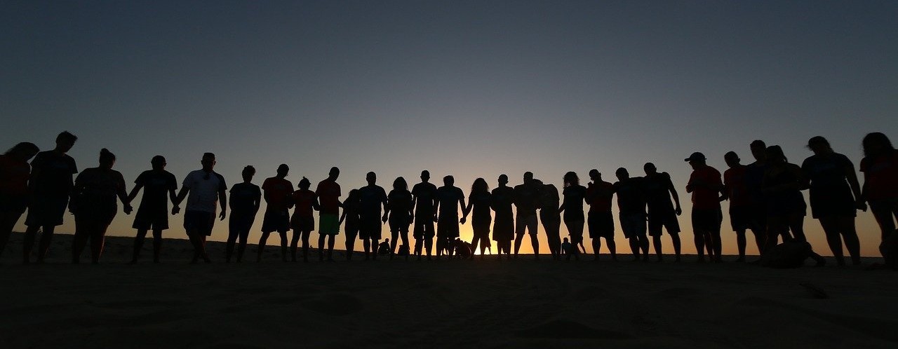 Many people standing together side by side