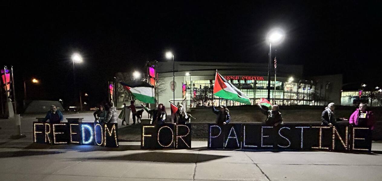 People holding Freedom For Palestine sign