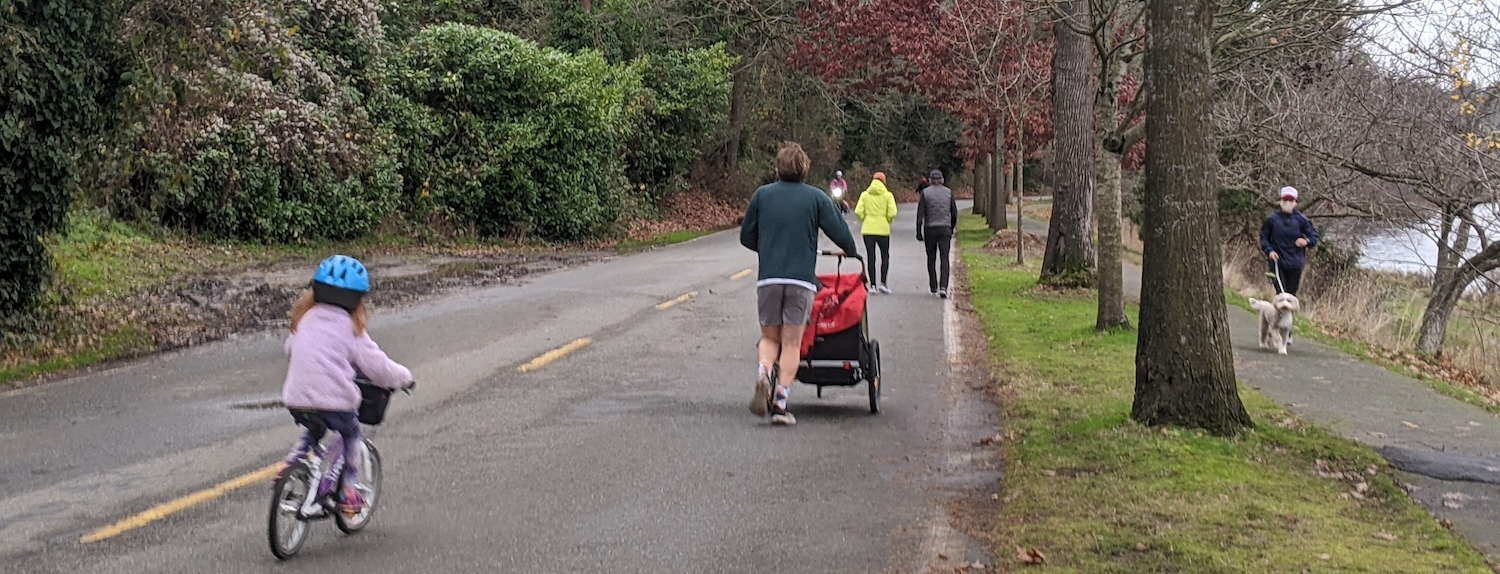 Photo of people including a child on a bike enjoying LWB