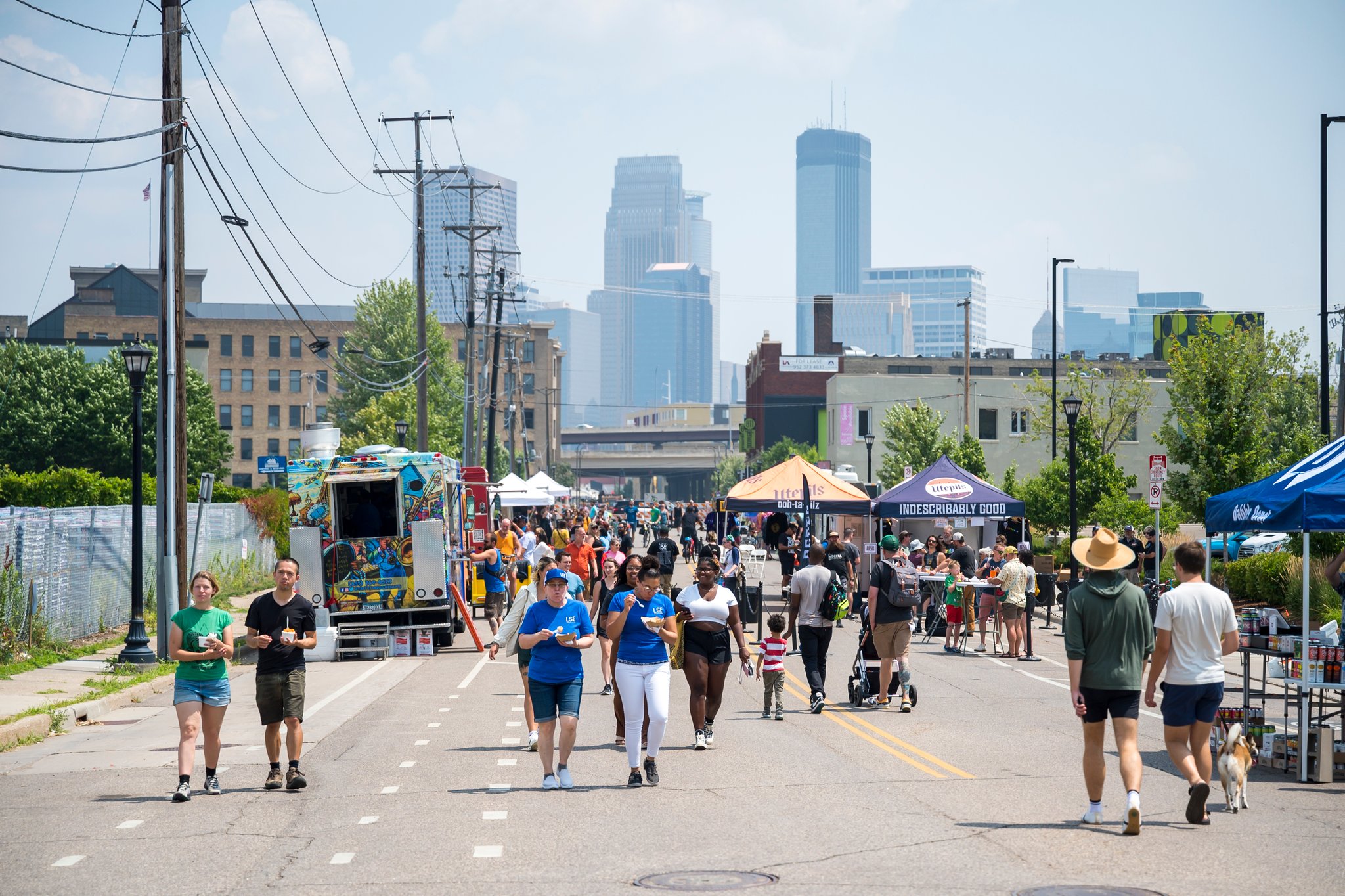 people on closed glendwood ave with Minneapolis skyline in the background