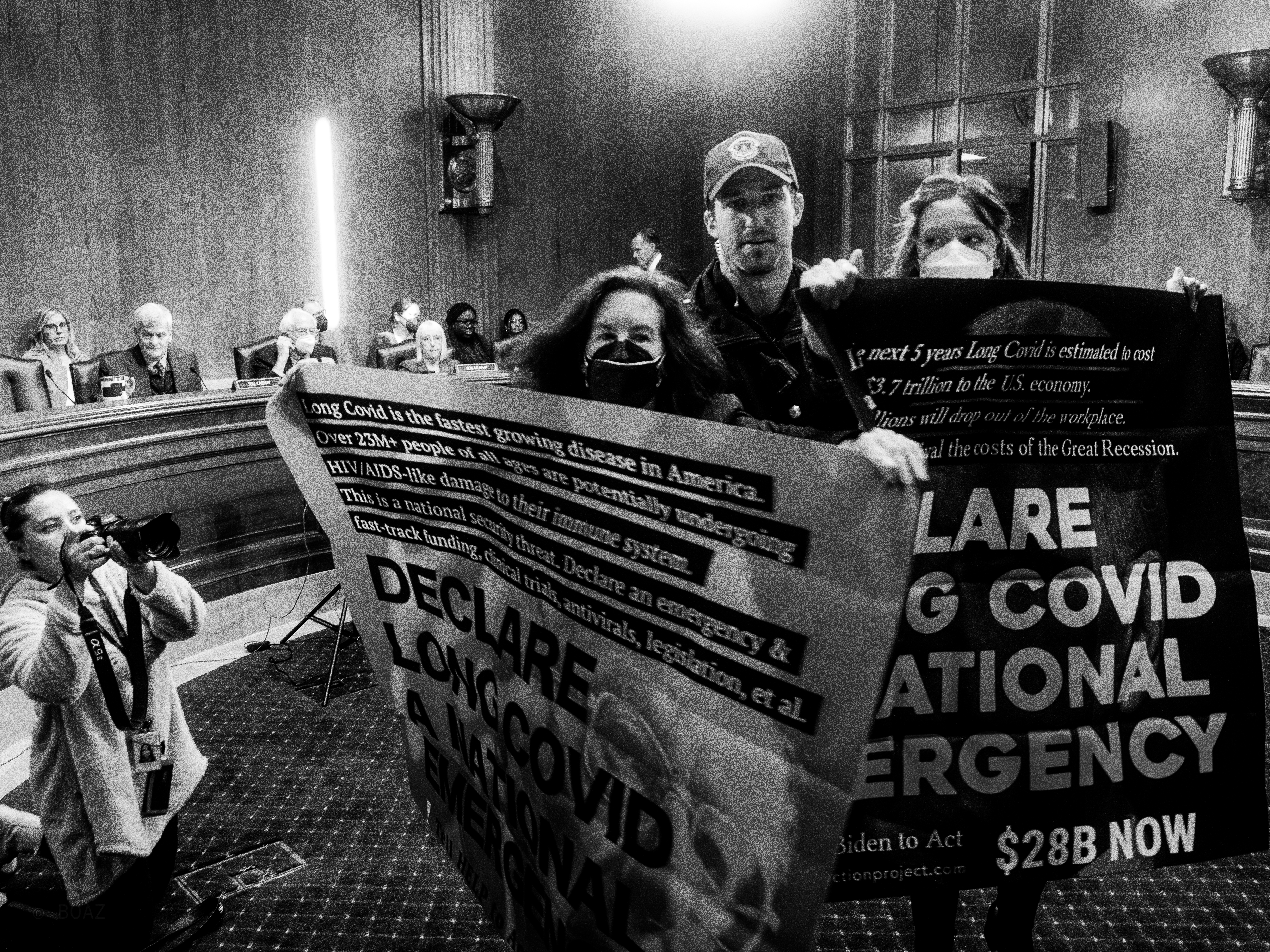 Two LCAP activists held the first direct action for #LongCovid in D.C. disrupting Senators at the committee, chanting "LCAP Fights Back, Declare Long Covid a National Emergency, Antivirals Now".