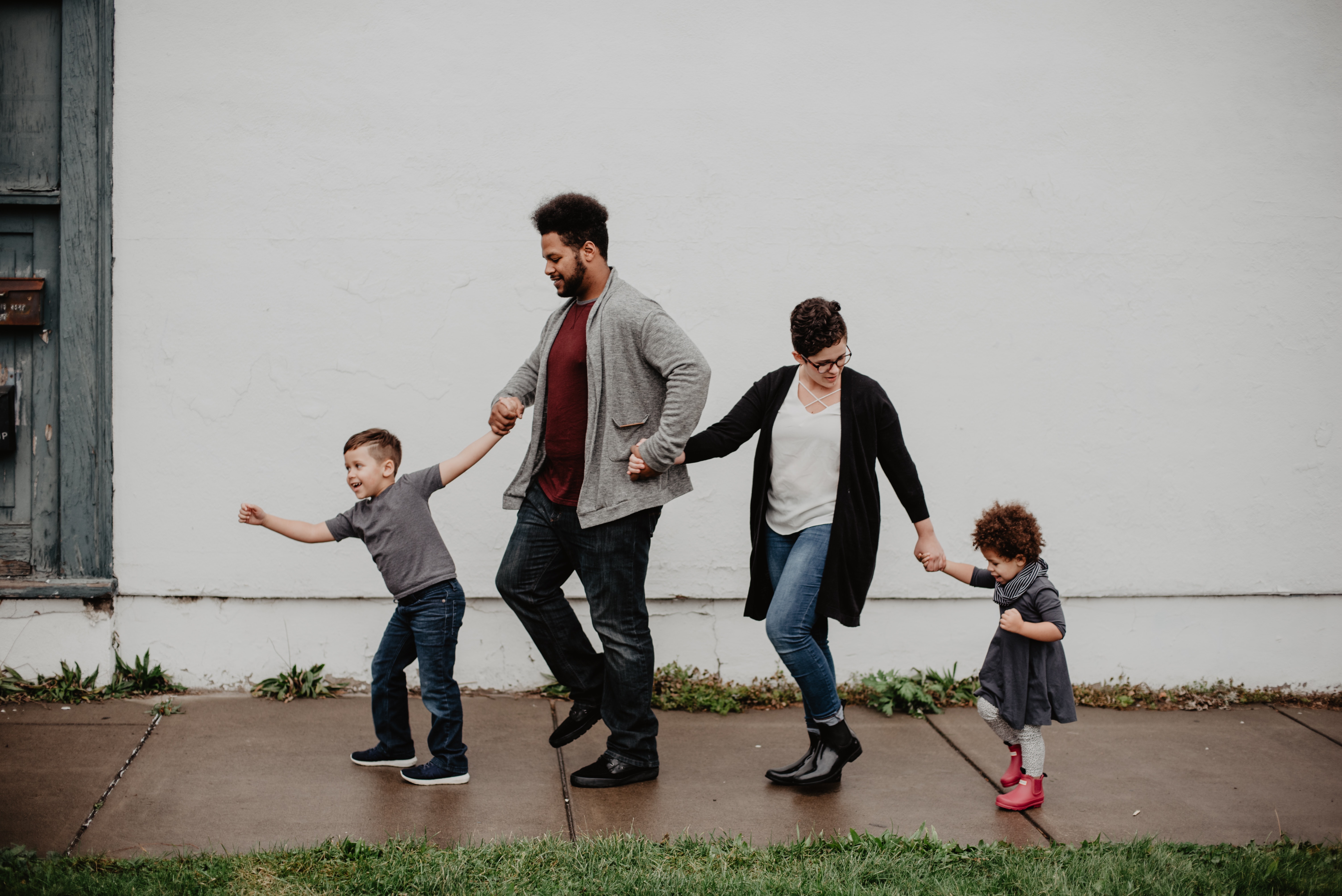 Parents and two kids walking hand in hand