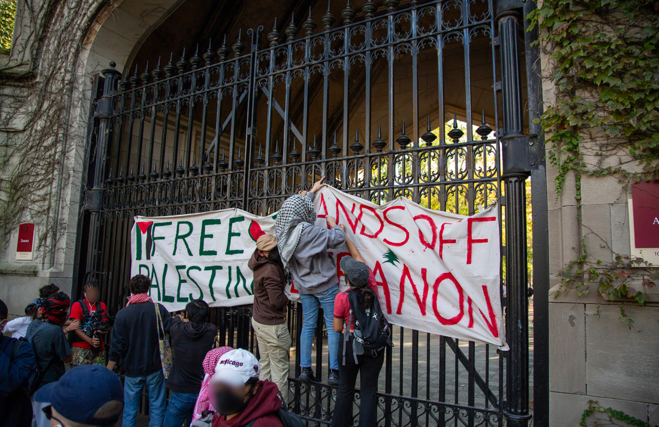 After locking Cobb Gate, protesters hang a banner reading "Free Palestine" and "Hands off Lebanon"