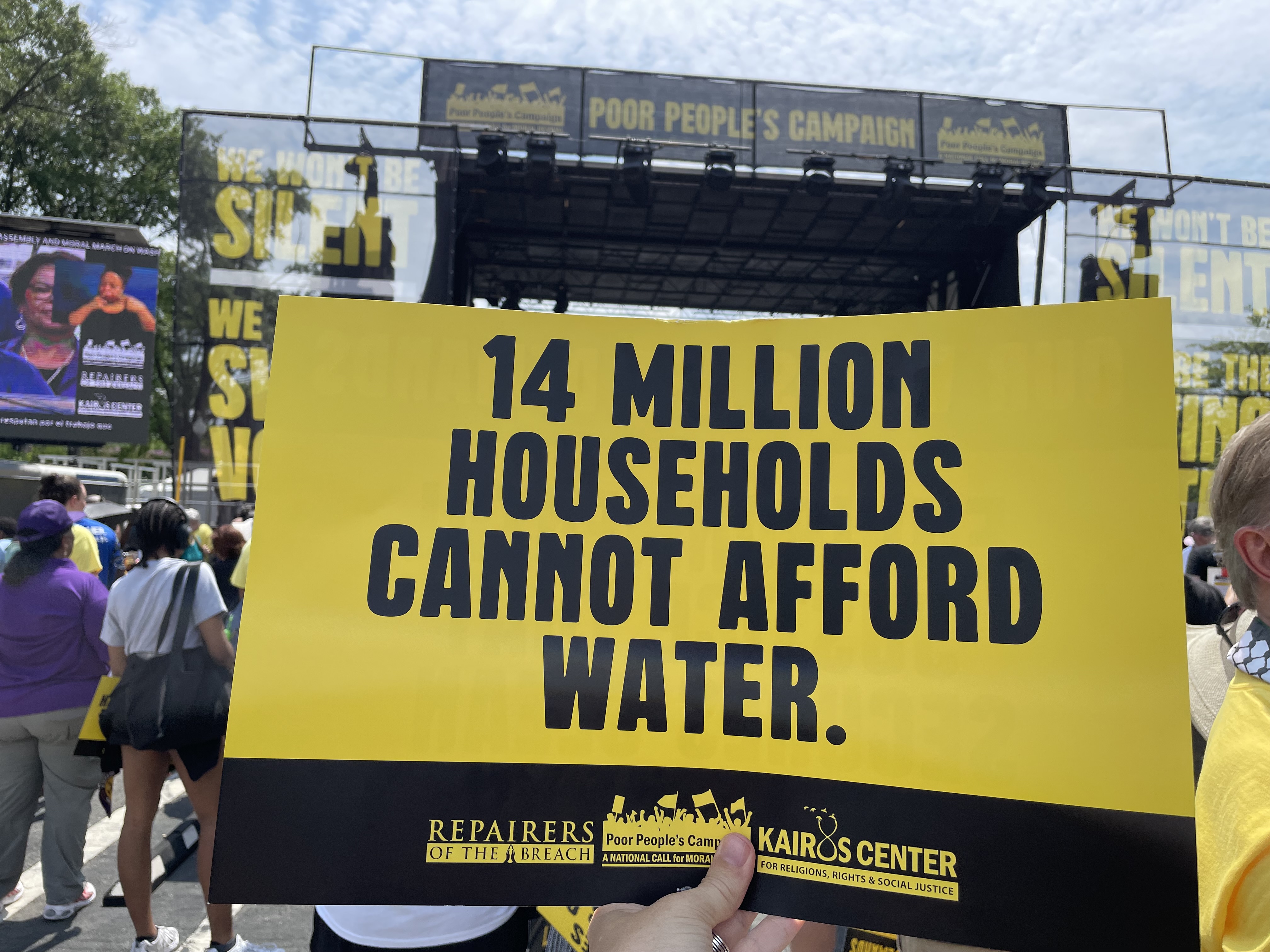 Sign reading 14 million people cannot afford clean water from Poor People's Campaign rally/march in D.C.