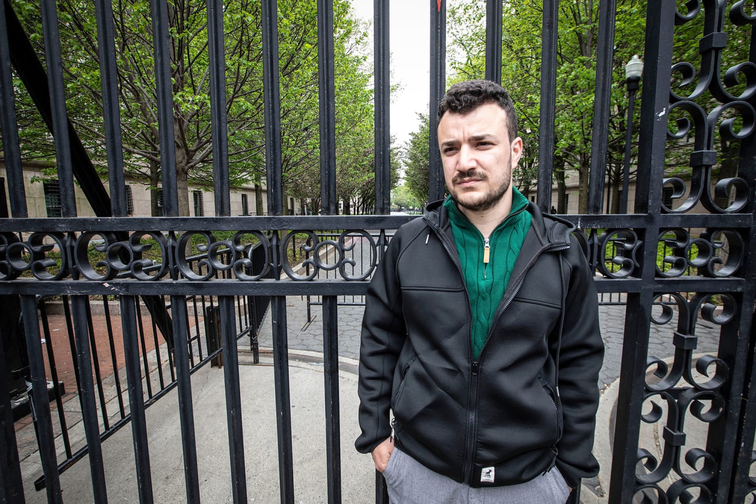 Mahmoud Khalil standing in front of a gate at Columbia University