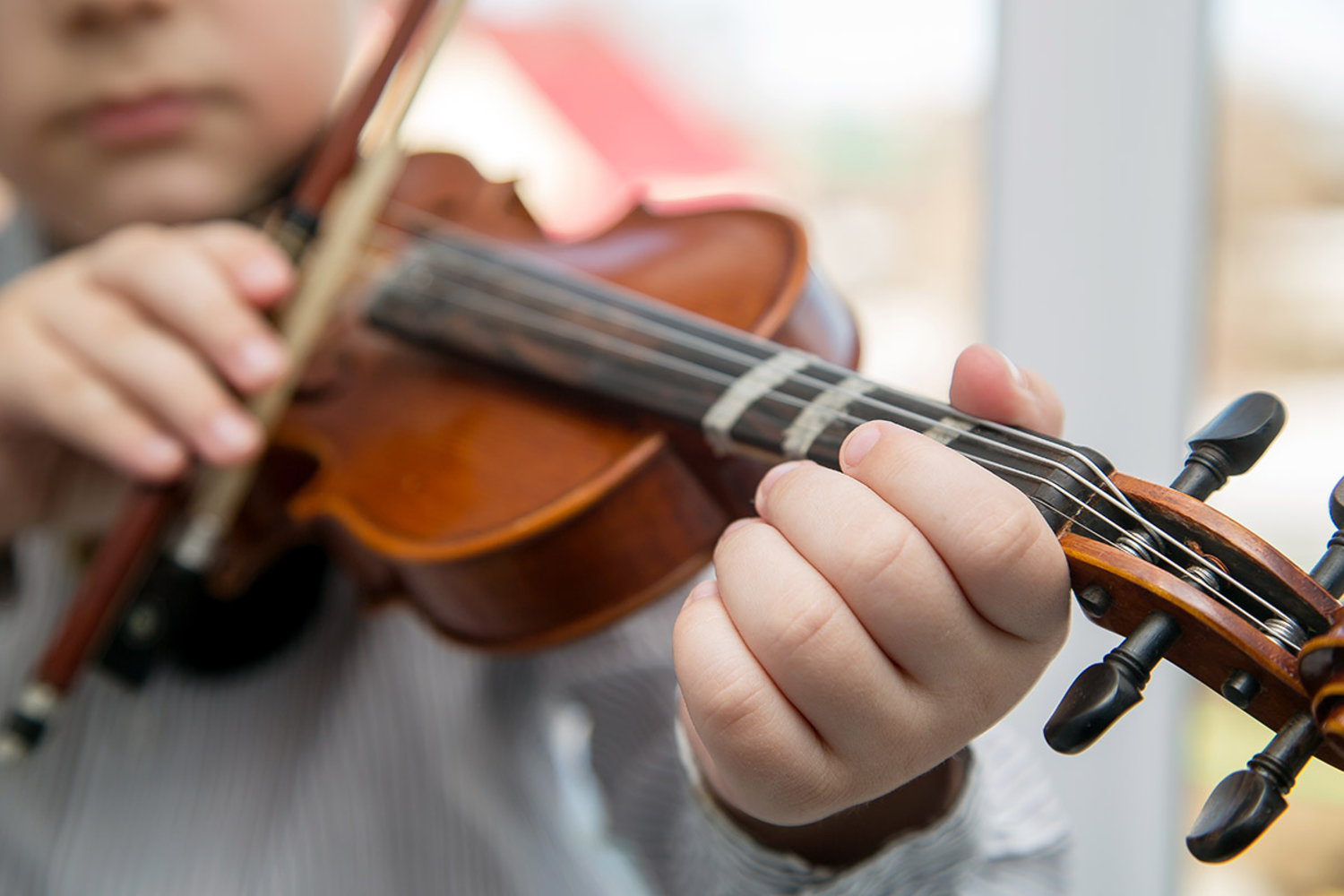 Child playing string instrument