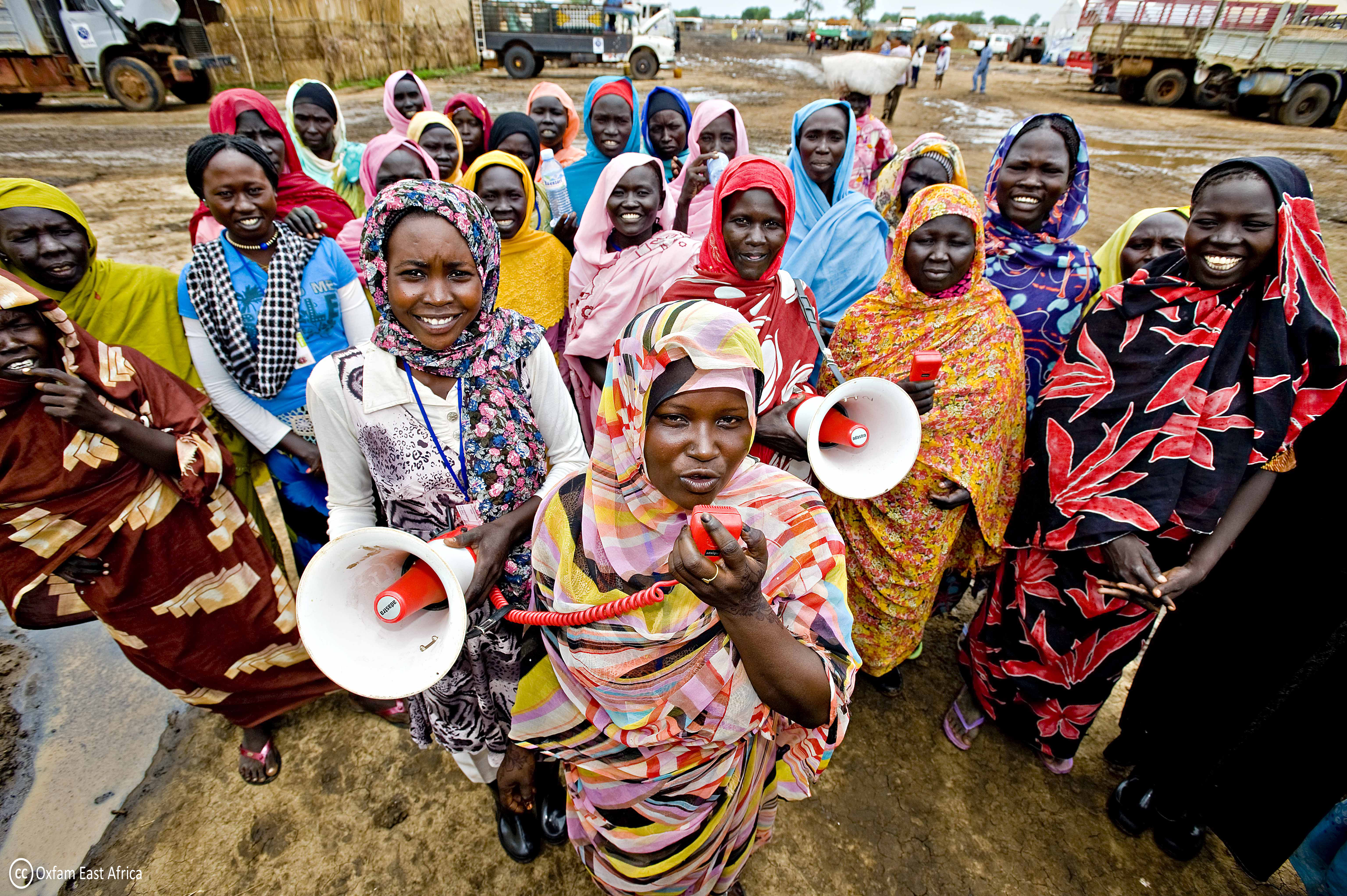  a group of women, including voluntary members of an Oxfam water and sanitation committee in the Jamam refugee camp, using megaphones to share hygiene messages and distribute female hygiene kits
