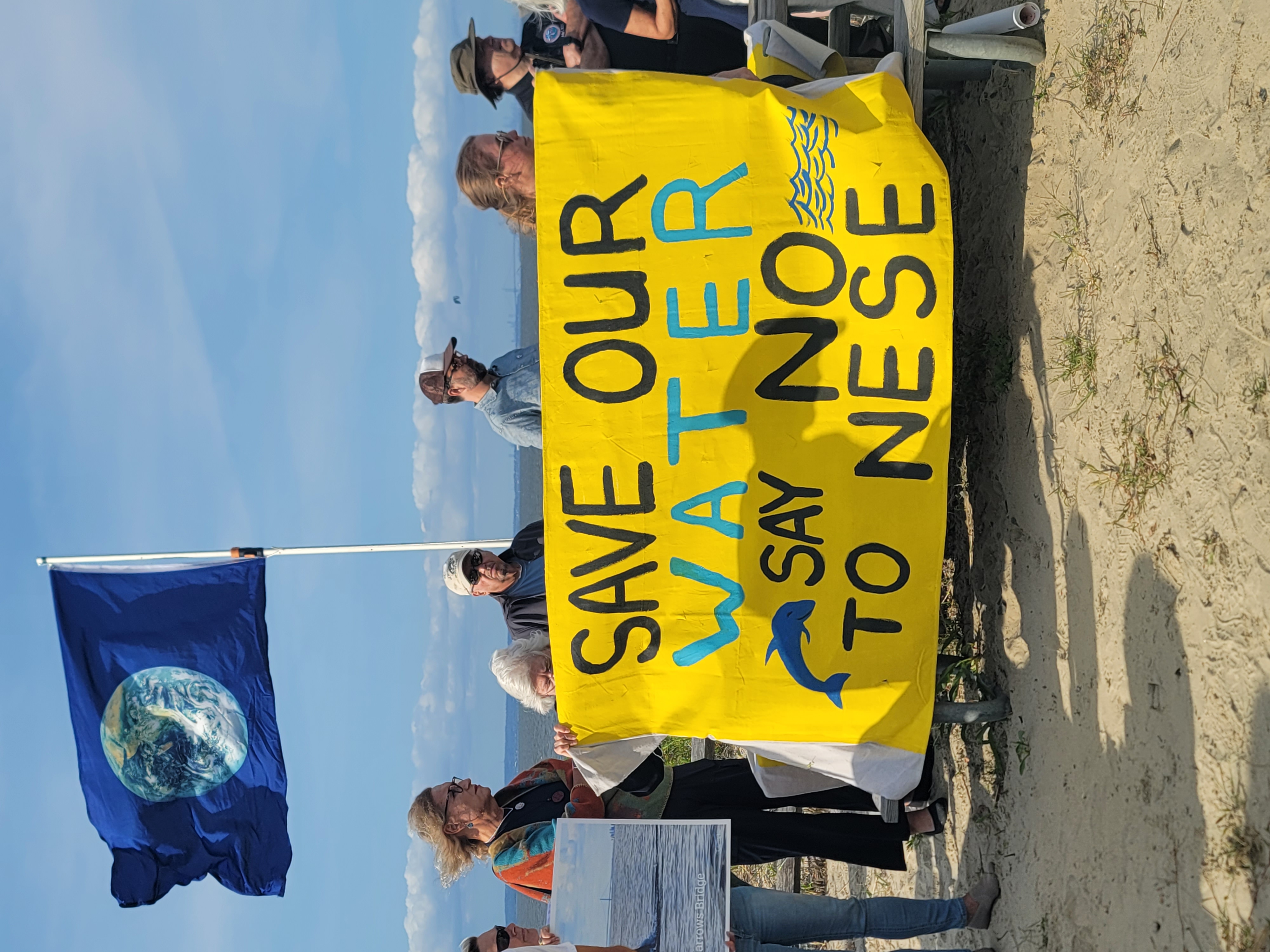 Coalition holding a banner to urge leadership to DENY approval of an unnecessary toxic project dubbed "NESE"