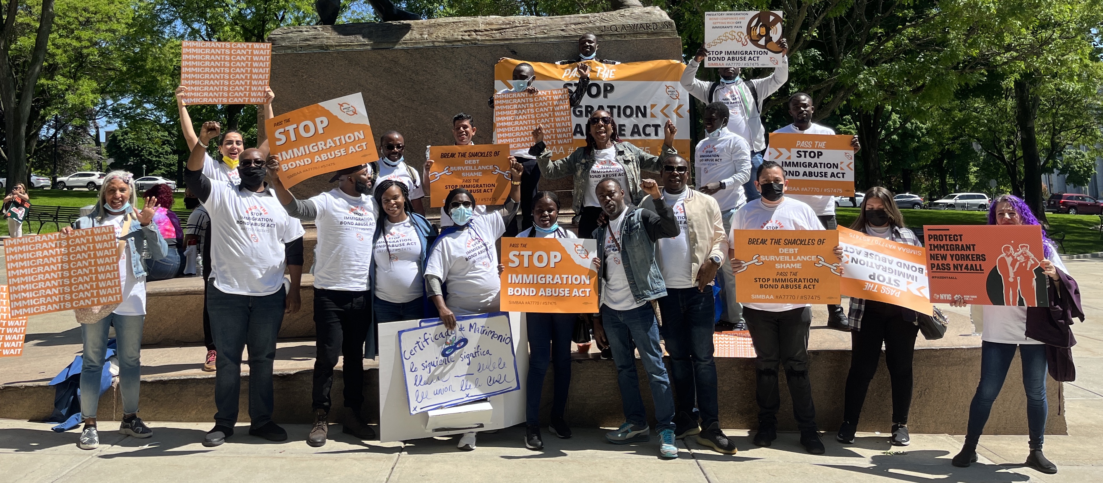 Few dozen members of the Break the Shackles coalition that are holding sighs that say, "pass the Stop Immigration Bond Abuse Act"!