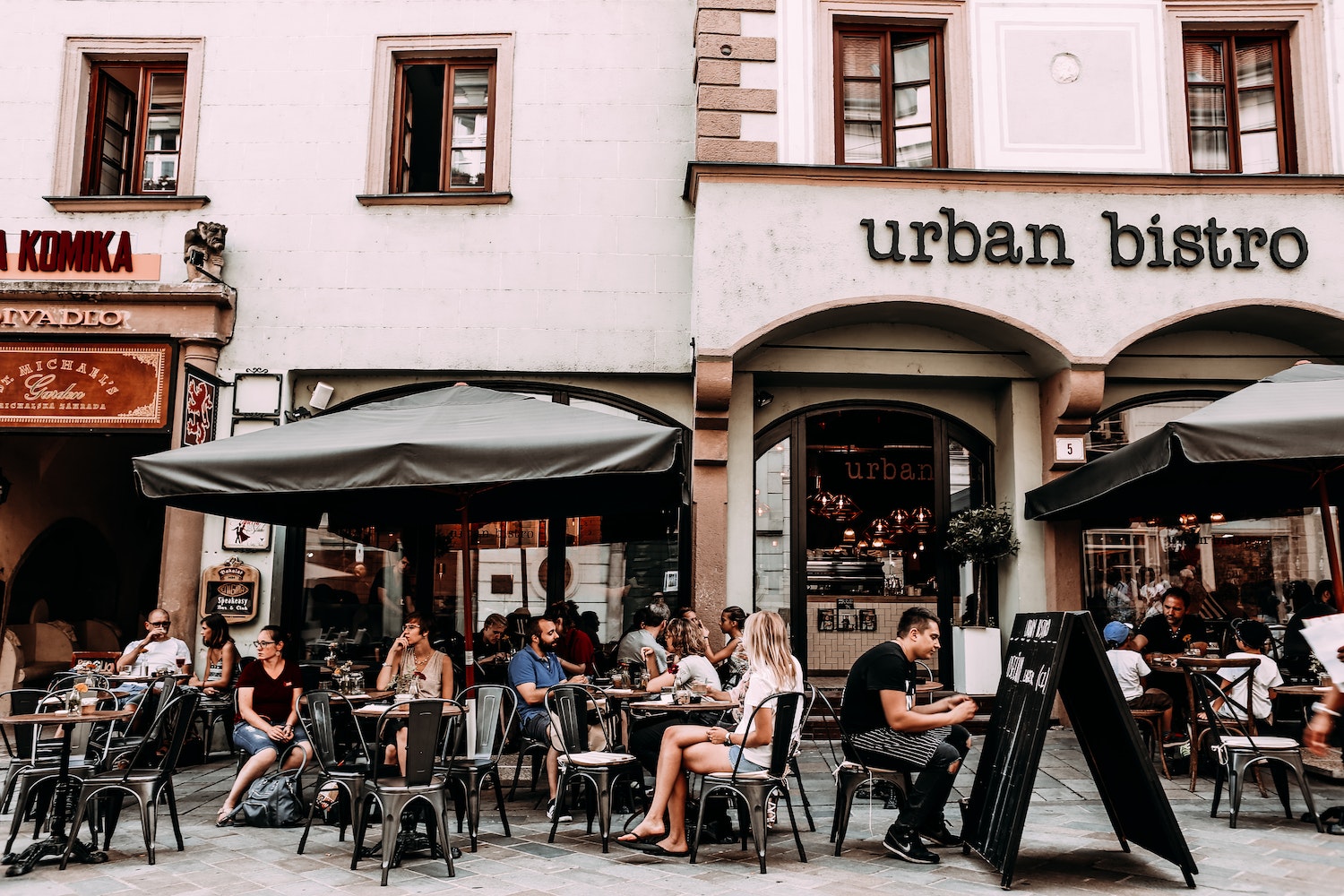 Street cafe with people and tables