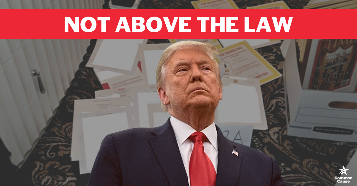 Donald Trump in front of a picture of the stolen documents. Text says Not Above The Law