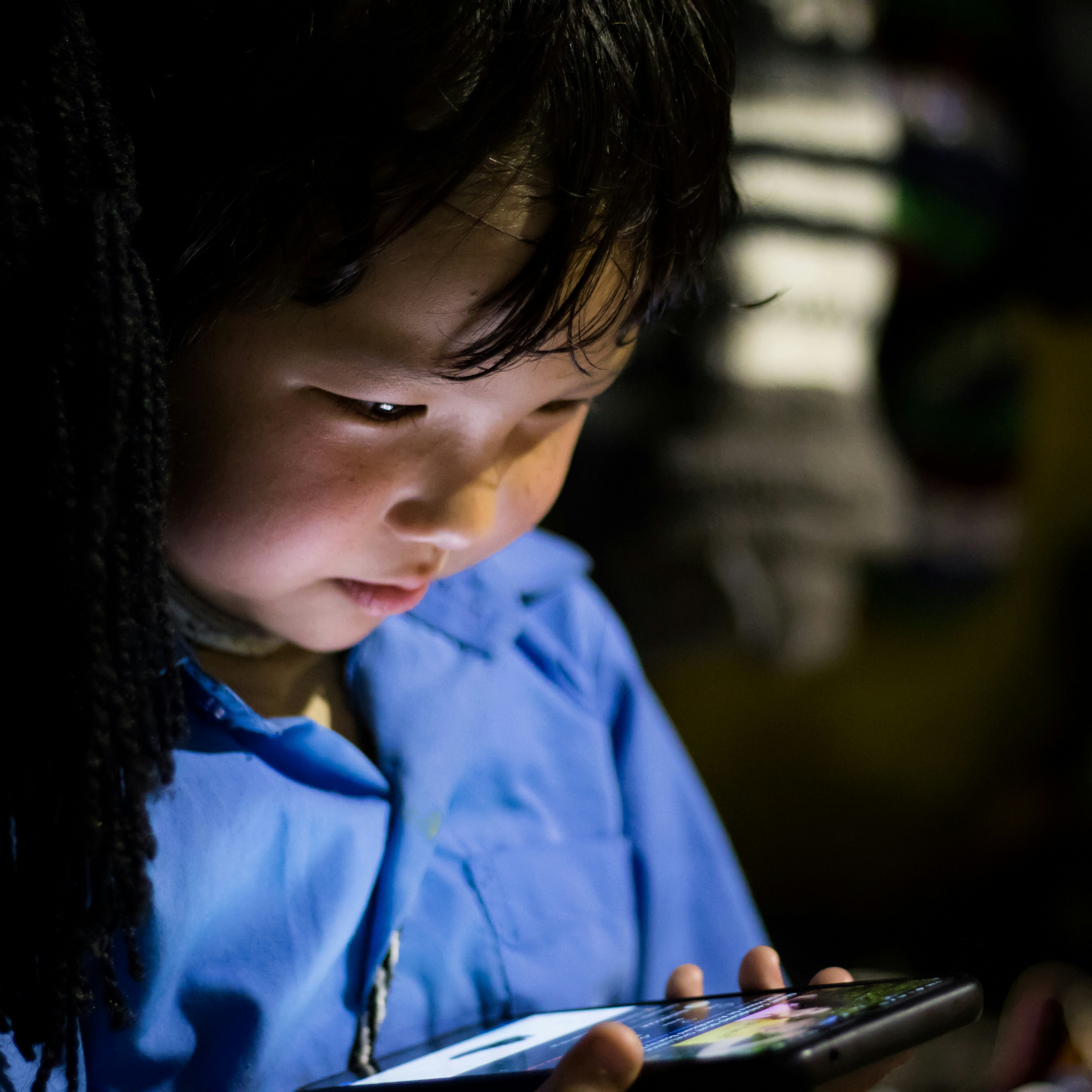 Young boy looking at phone