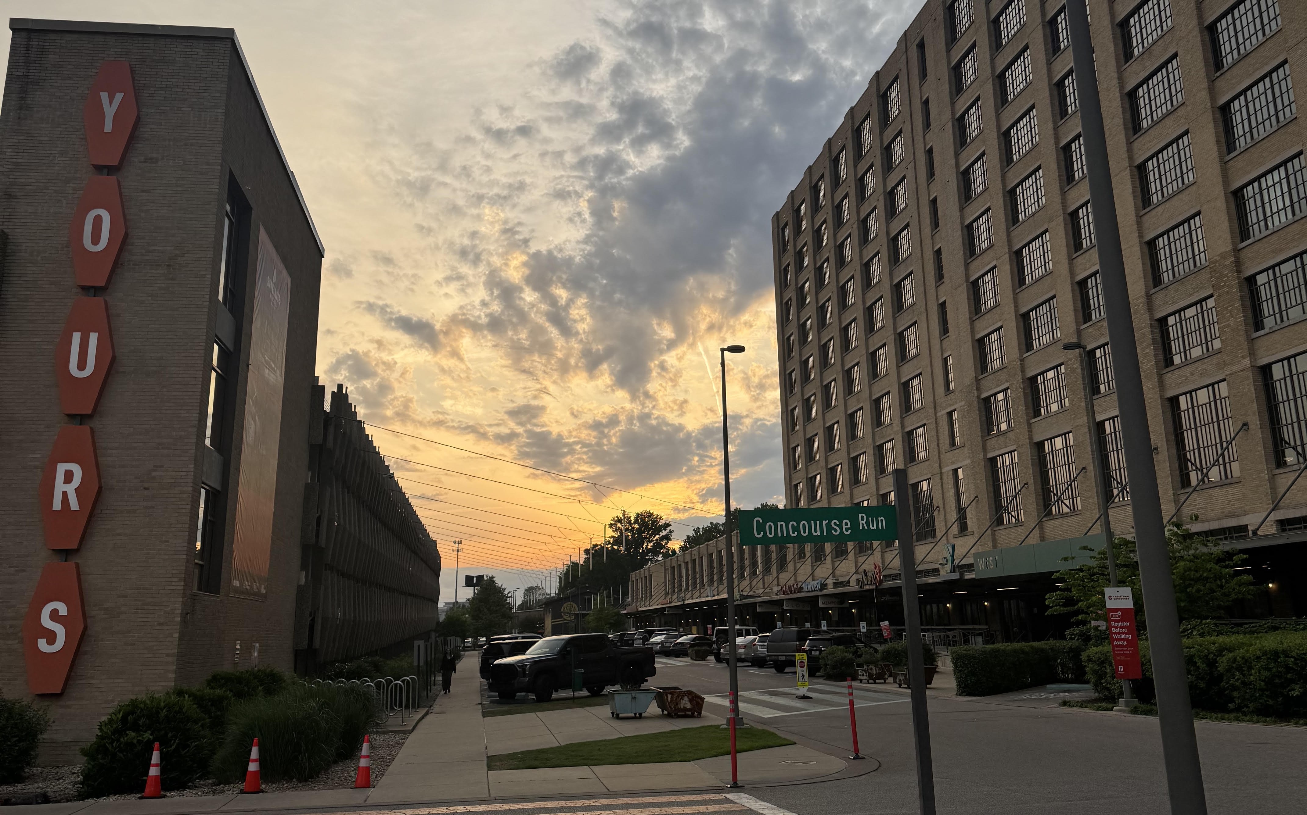 Crosstown Concourse at sunset, with the parking garage that says "YOURS" in the foreground
