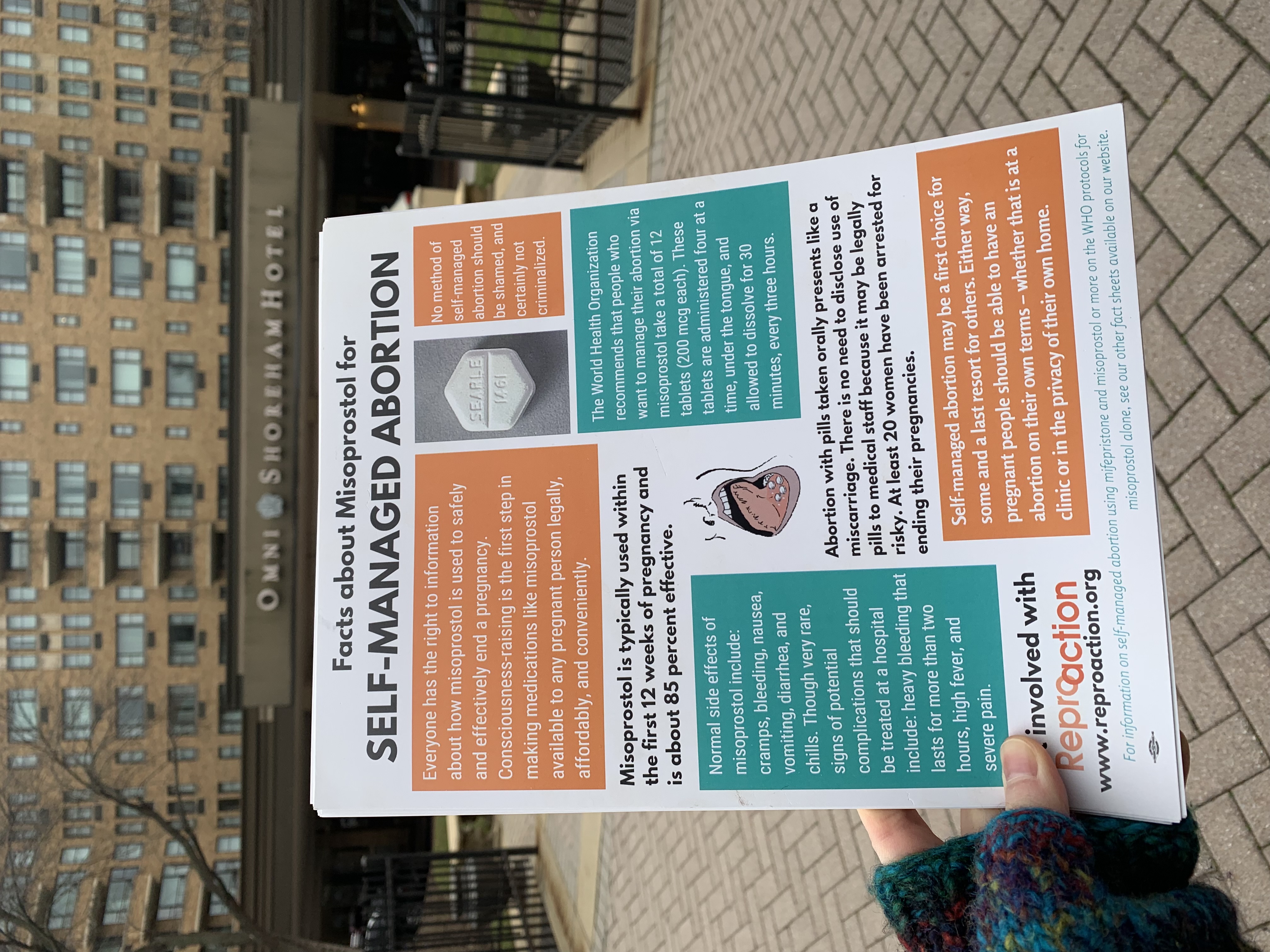 someone holding a flyer indicating the protocol for self-managed abortion with pills