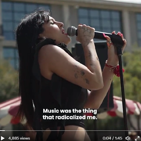 Image from recap video. Emmy Meli performing with caption reading "Music was the thing that radicalized me."