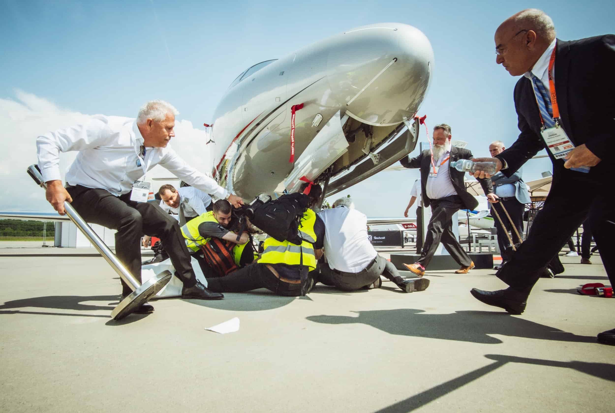 Security rush in to pull activists from the base of a private jet
