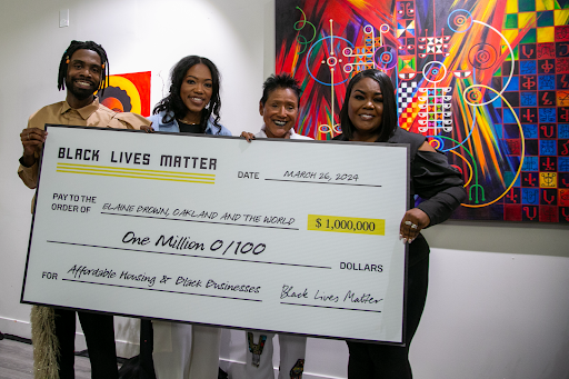 BLM board tholding big check of $1mil to OAW