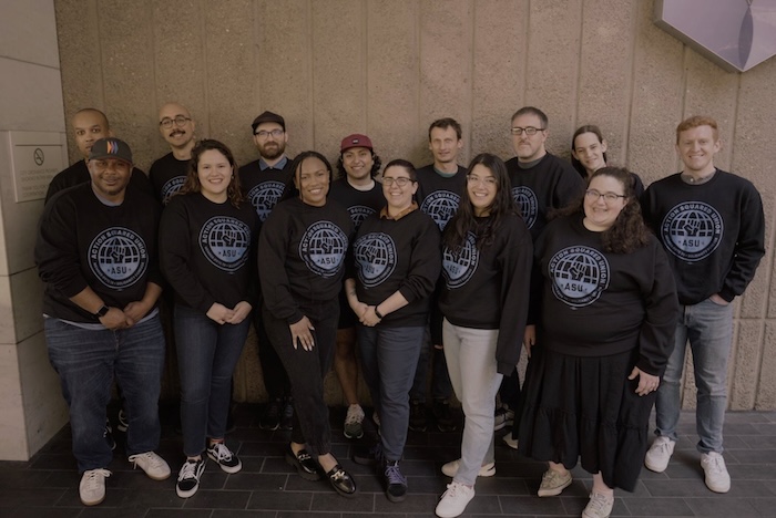 The Action Squared Union posing in matching sweatshirts