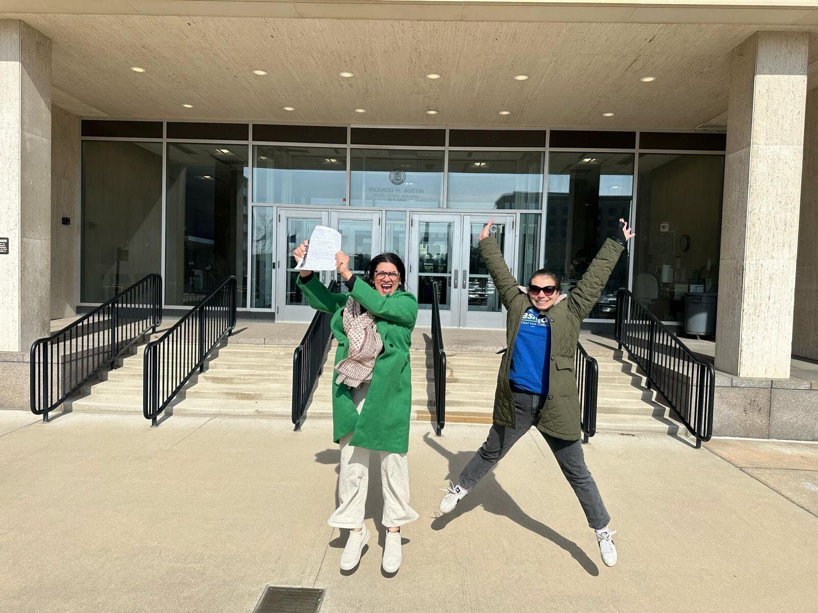 Rashida jumping to celebrate turning in her petition signatures.