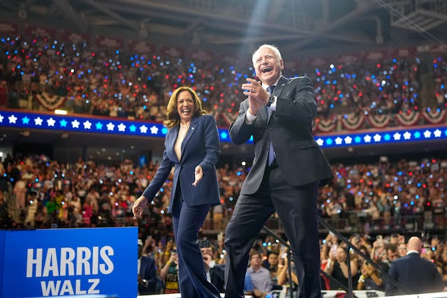 Kamala Harris and Tim Walz entering a rally