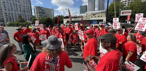 Acting Secretary of Labor Julie Su speaks with striking CWA members