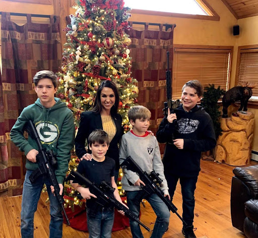 Rep. Lauren Boebert with her sons holding AR-15-style rifles