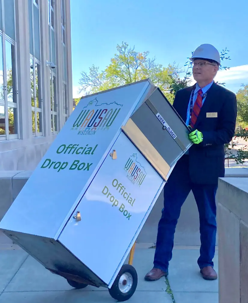 Wausau Mayor Doug Diny removing a drop box