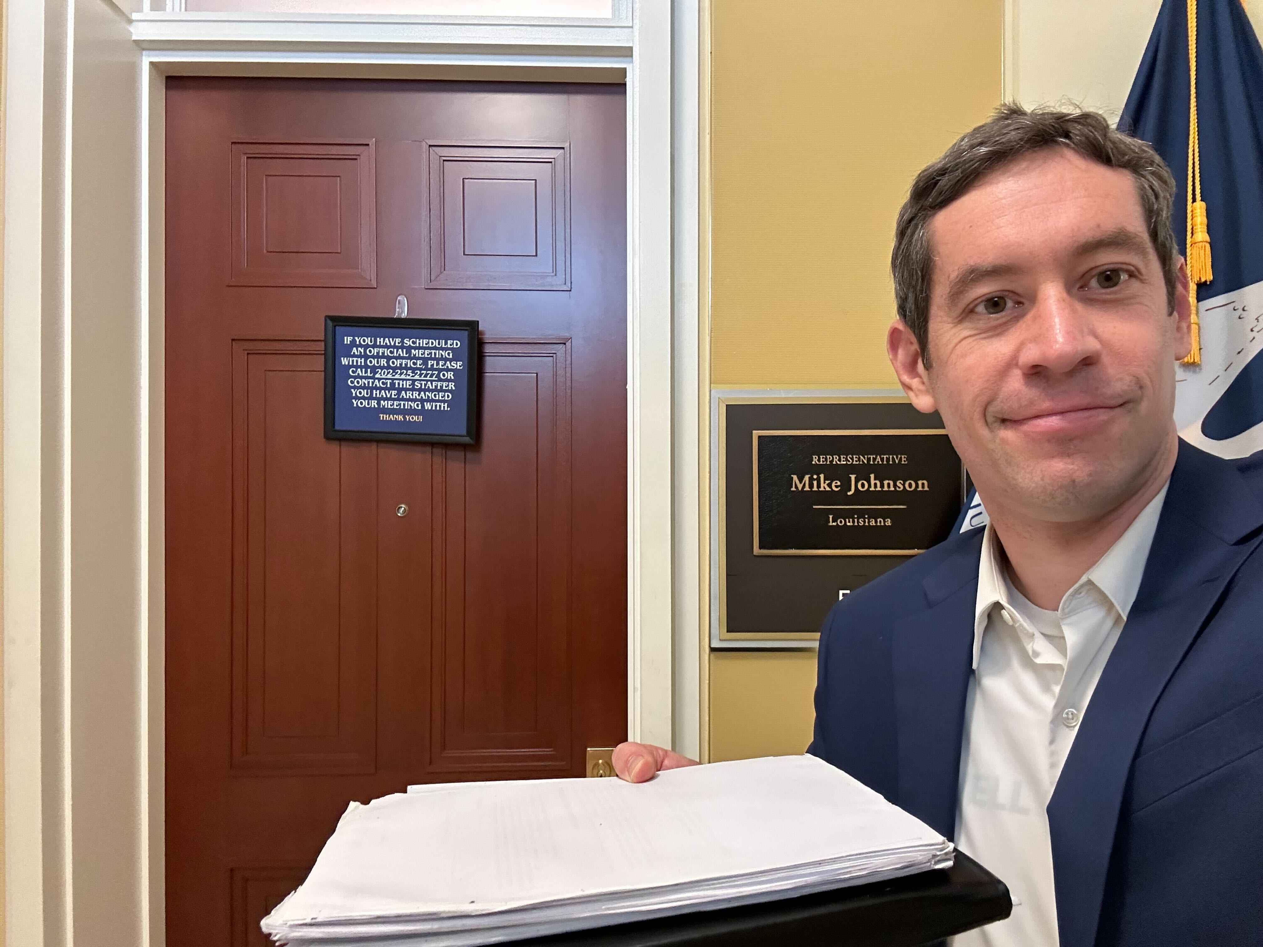 Photo of Aaron Scherb, Common Cause Senior Director of Legislative Affairs, delivering petition signatures.