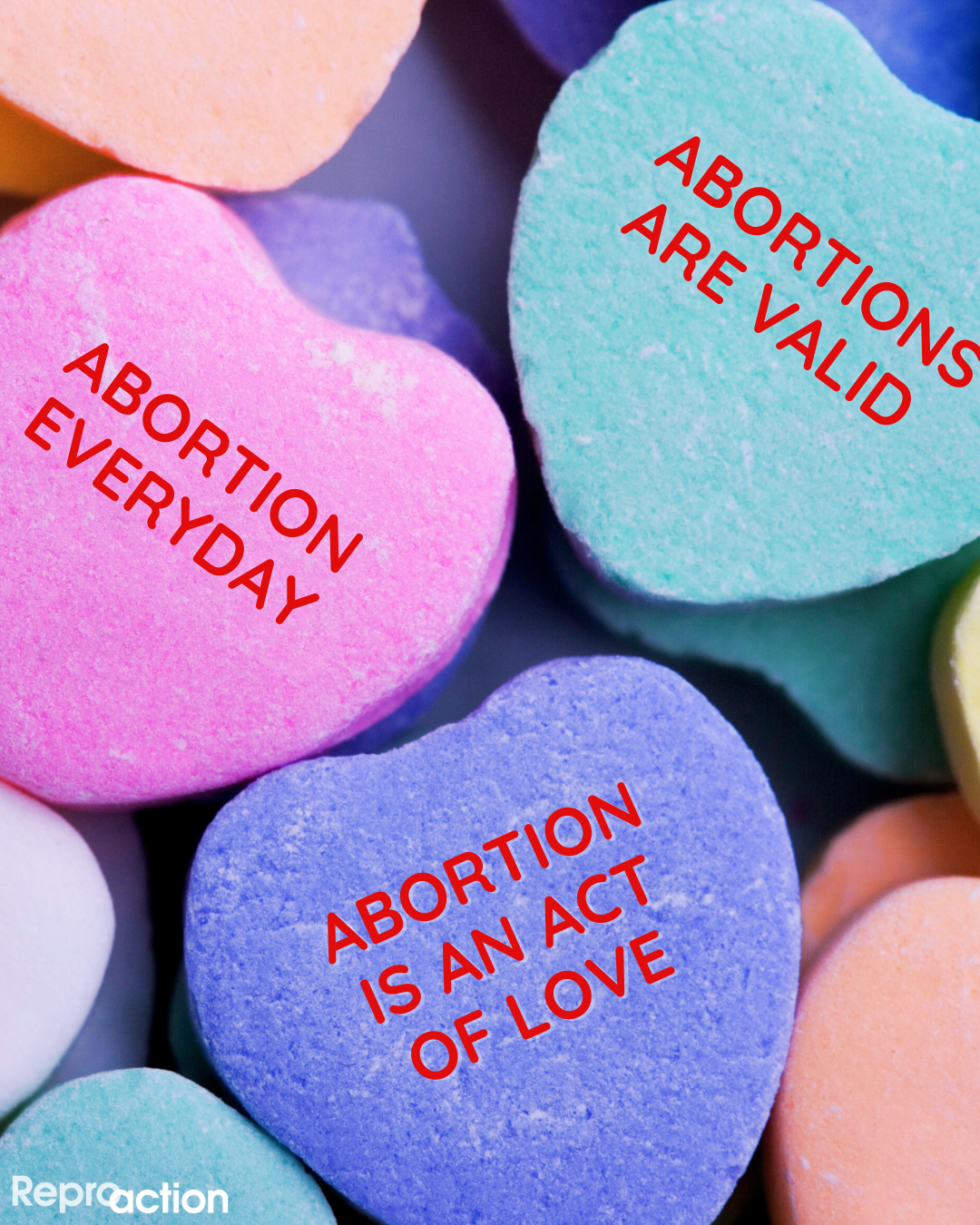 Three candy hearts read “Abortions are valid, abortion everyday, and abortion is an act of love” to the left is the Reproaction logo in white.