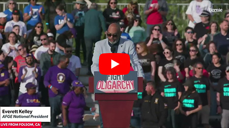 President Everett Kelley speaks behind a podium that says Fight Oligarchy