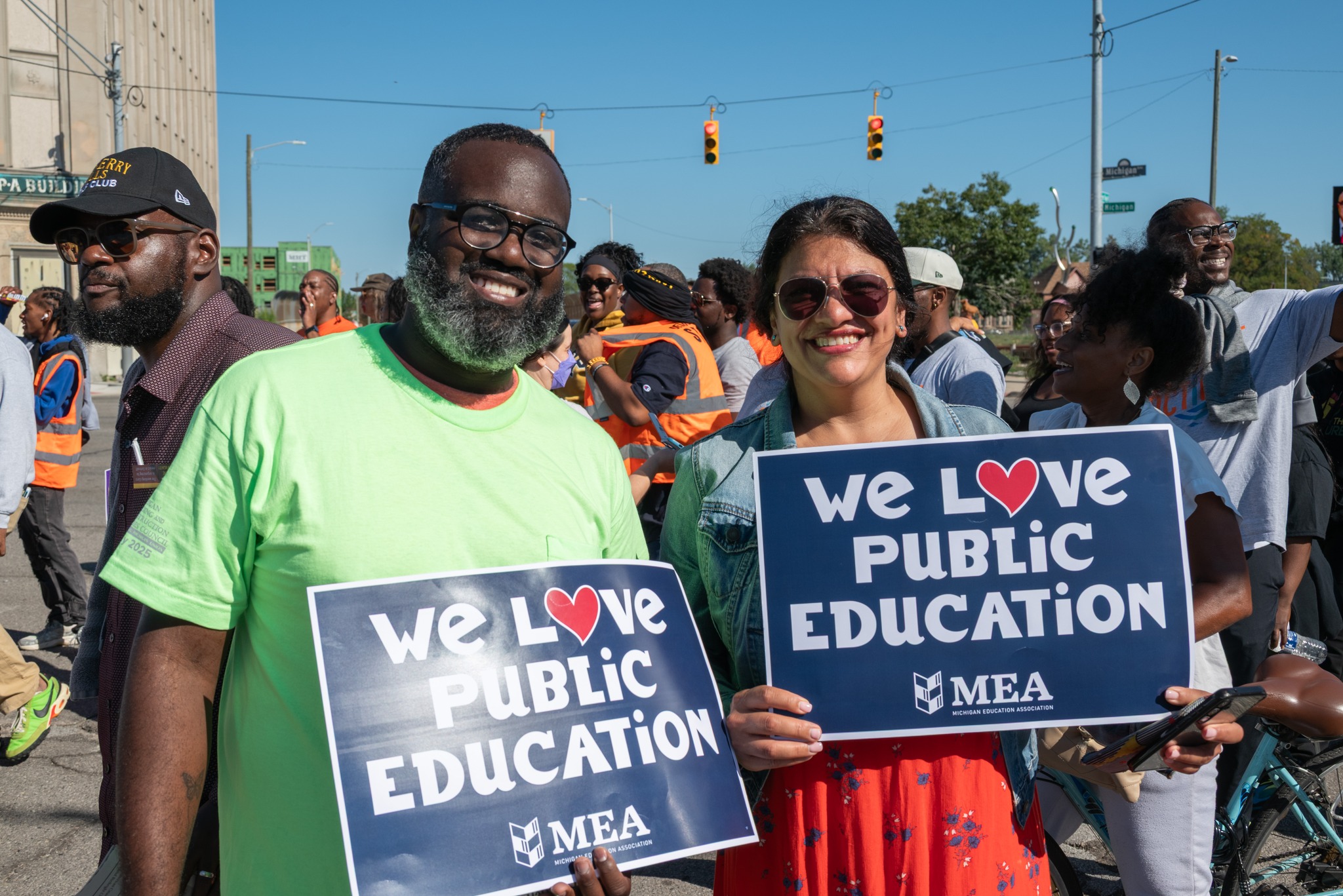 Rashida holds a sign that says We Love Public Education