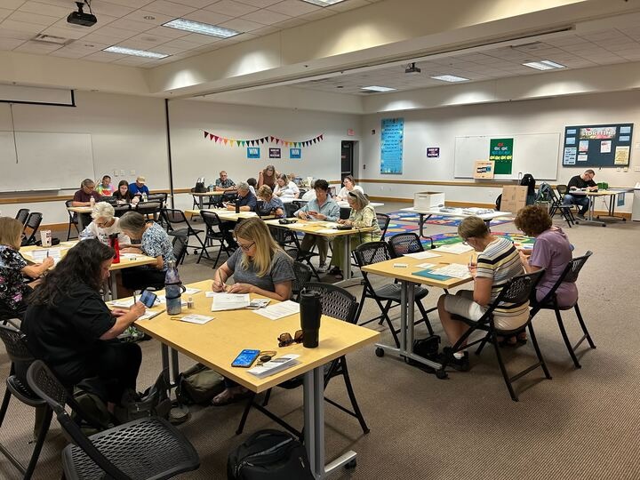 MoveOn members gathered in a classroom to write postcards MoveOn members gathered in a classroom to write postcards