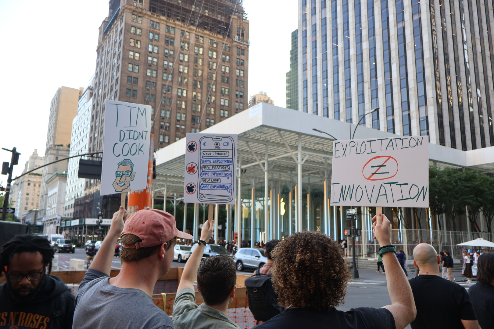 protest signs against Apple outside of NYC Apple Store