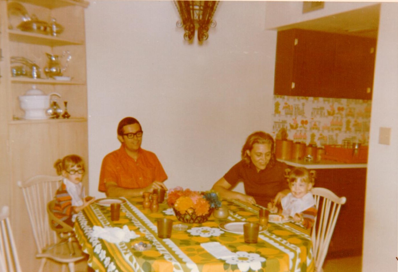 Vintage photo of Katie's family gathered around the dinner table.