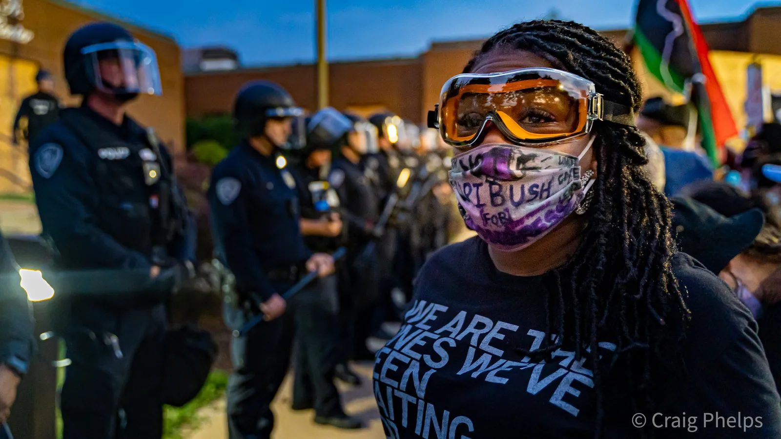 Cori Bush marches past a line of police in 2020