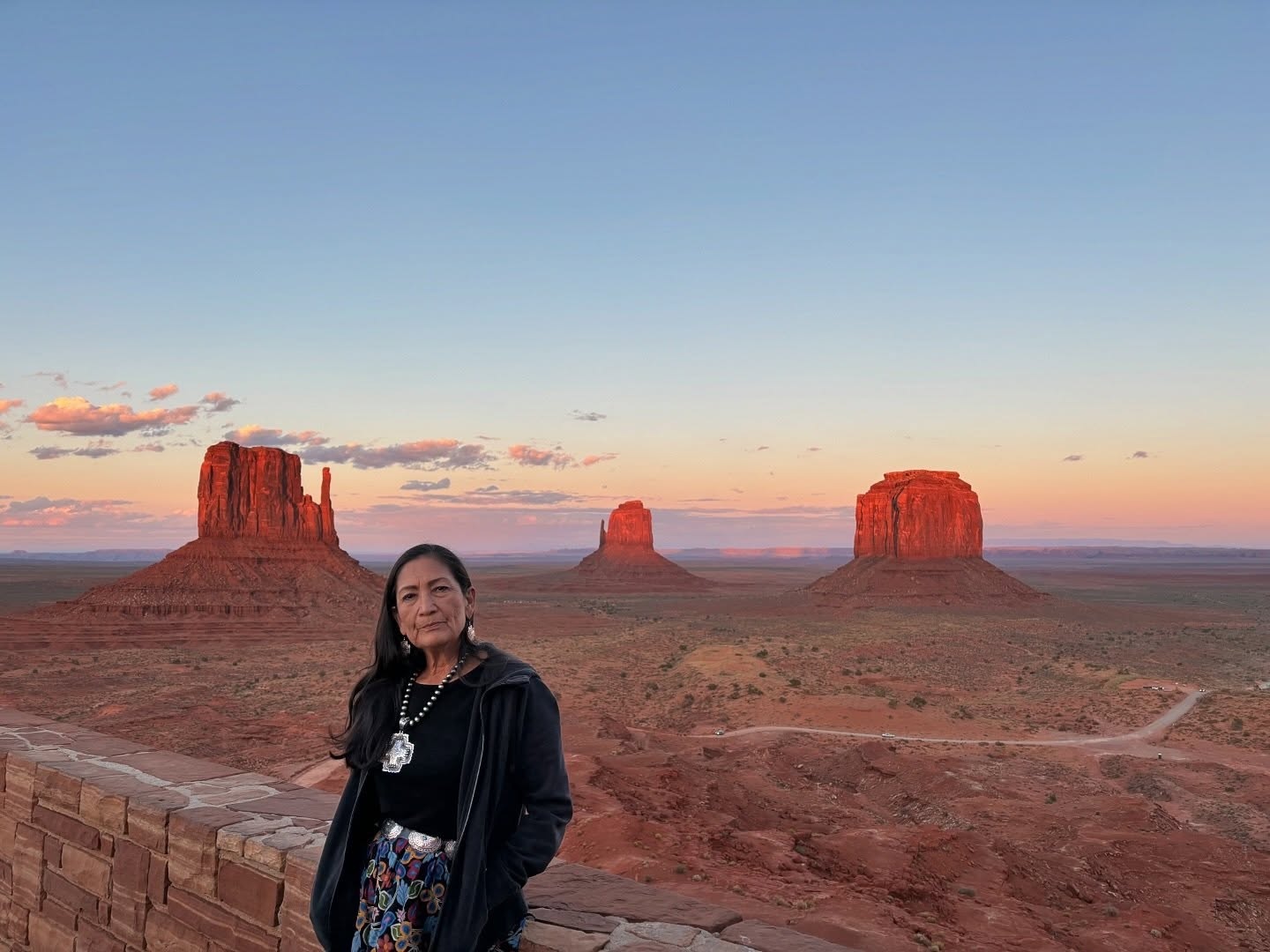 Deb stands before a beautiful sunset in Monument Valley Navajo Tribal Park
