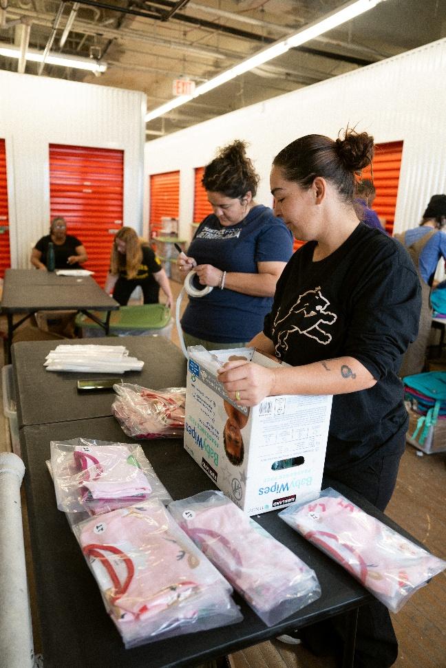Volunteers box up Rooted In Community Donations