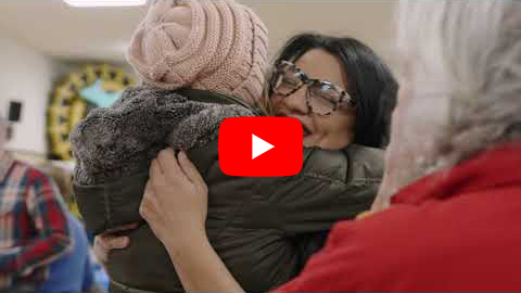 Still from Rashida's campaign kickoff video, in which the Congresswoman is hugging a child