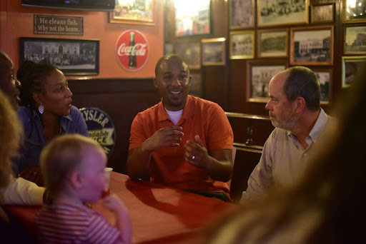 Scott speaking with neighbors at a bar