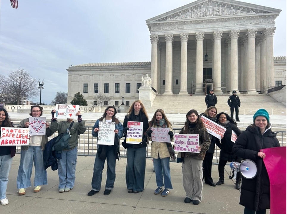 A group of volunteers holding homemade signs in favor of abortion rights. A group of volunteers holding homemade signs in favor of abortion rights.